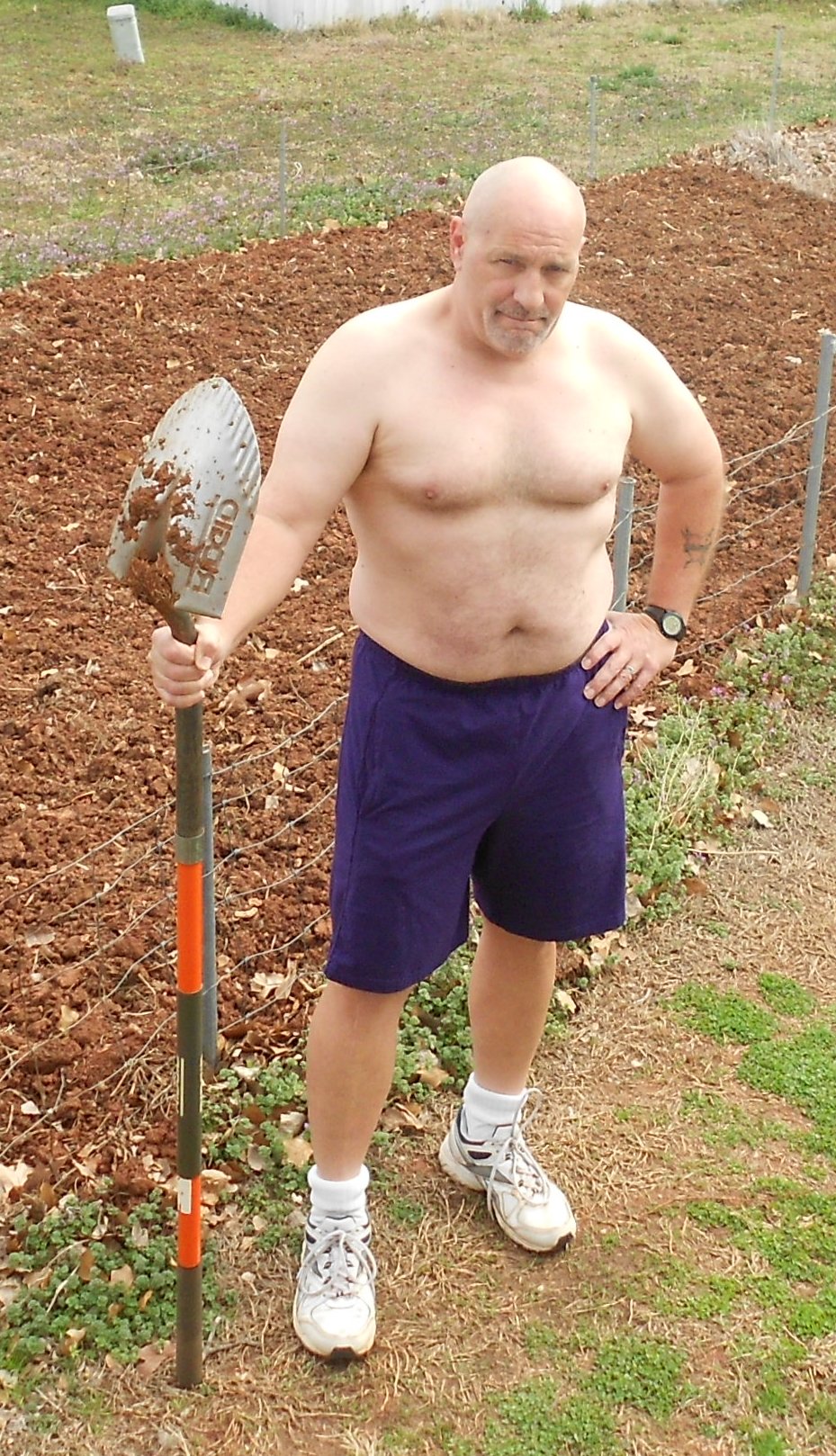 Ed shirtless with garden and shovel